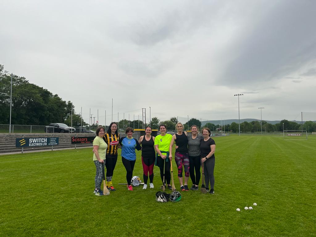 Past Glen camogie players standing on Watty Graham’s pitch 