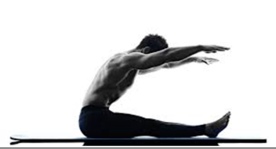 Man sitting on a mat stretching forward